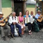 A street band takes a rest on a park bench, Mexico.