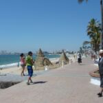 Locals and visitors stroll along the waterfront in Puerto Vallarta, Mexico.