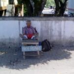 A man that repairs shoes in San Ignacio, Belize